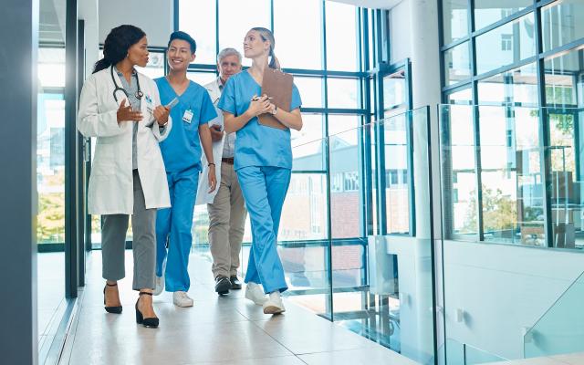physicians walking and talking in hospital hallway