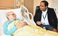 physician at the bedside of a patient
