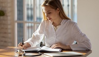 female student at a table studying