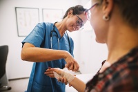 nurse putting a cast on a patient