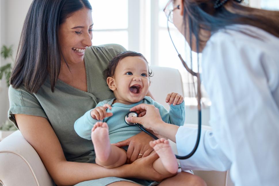 doctor using a stethoscope on baby