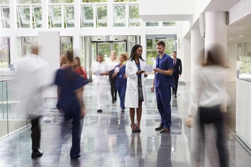 two physicians having a conversation in a hallway