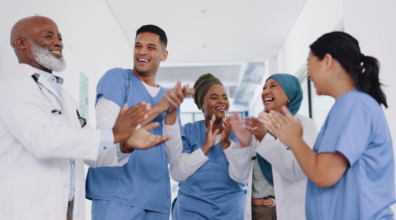 group of physicians celebrating and clapping