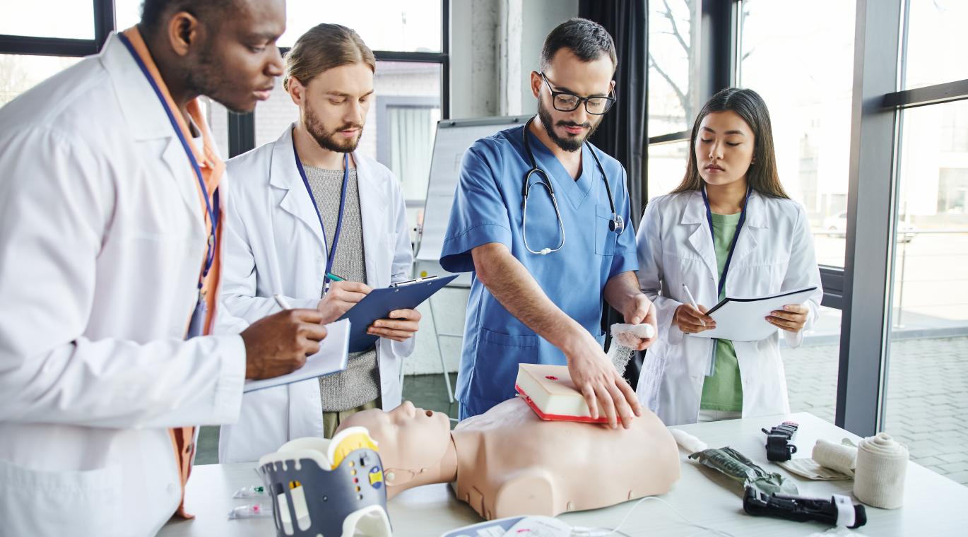 physicians practicing medicine on a manequin