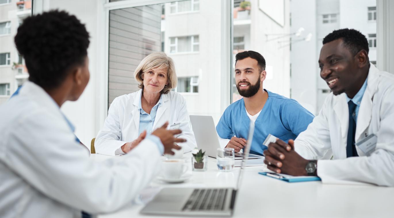 Doctor, team and happy with meeting in boardroom for healthcare diagnosis, surgery planning and medical workshop. 