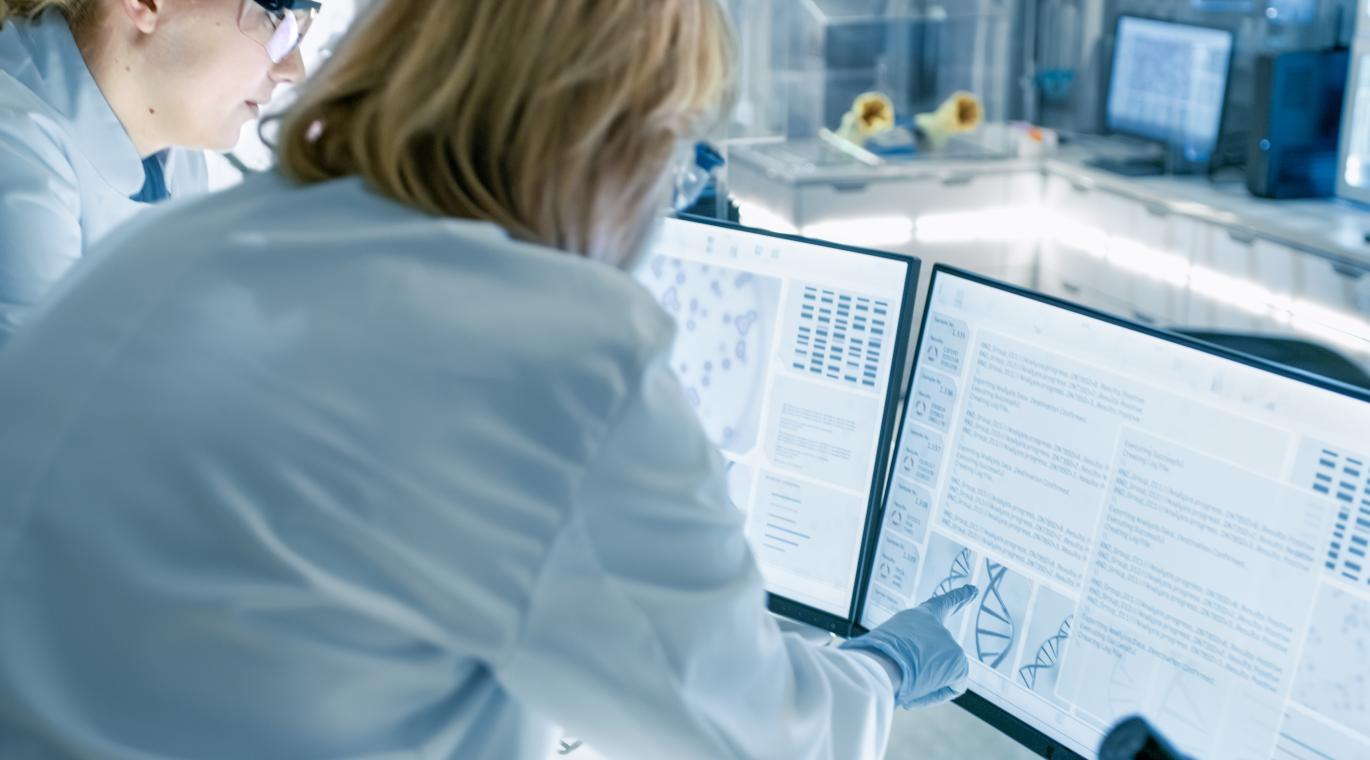 physicians looking at a computer screen with data