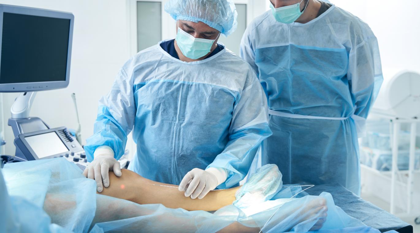 two surgeons looking at a knee