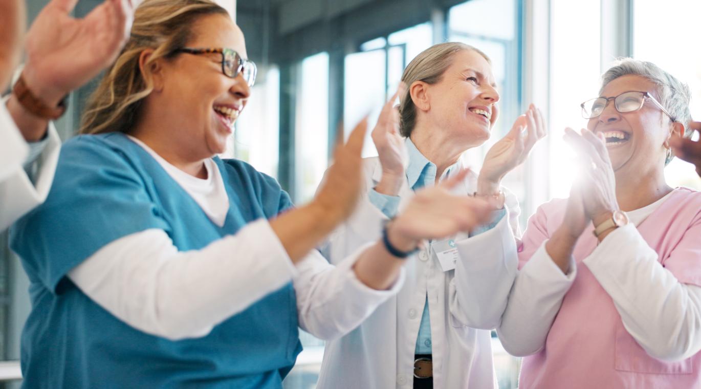 Doctor, support and applause in celebration for team unity, healthcare achievement or goal at the hospital.