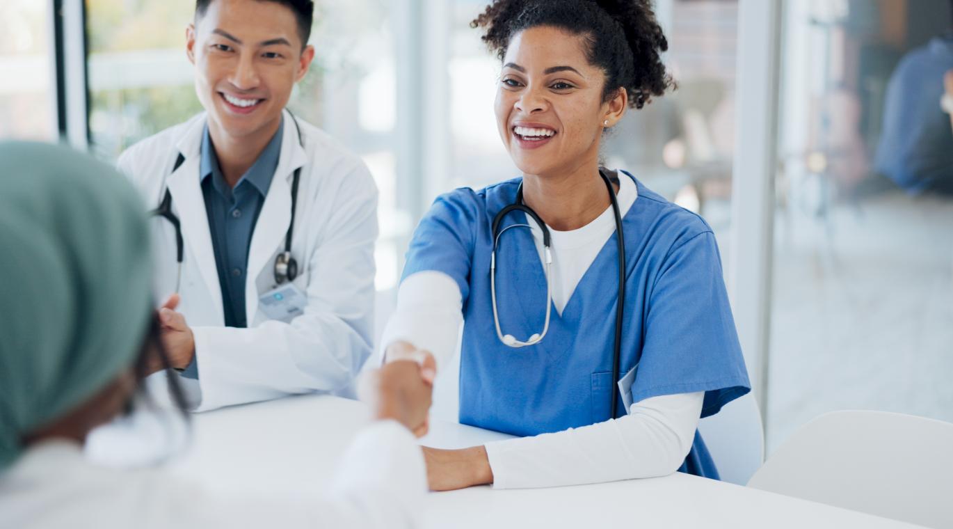 Doctors handshake, welcome and hospital team with applause, onboarding and kindness for new colleagues. 