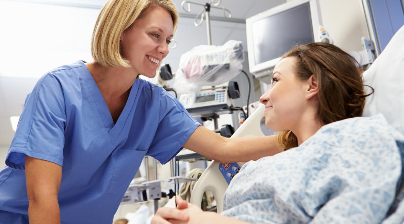 female physician smiling with female patient