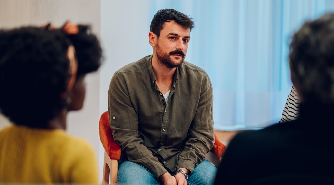 man sitting in support group