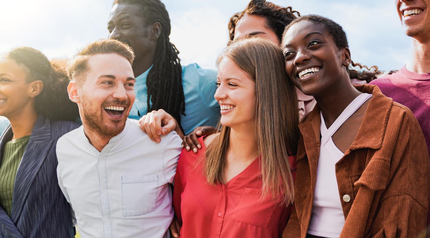 group of people arm in arm smiling