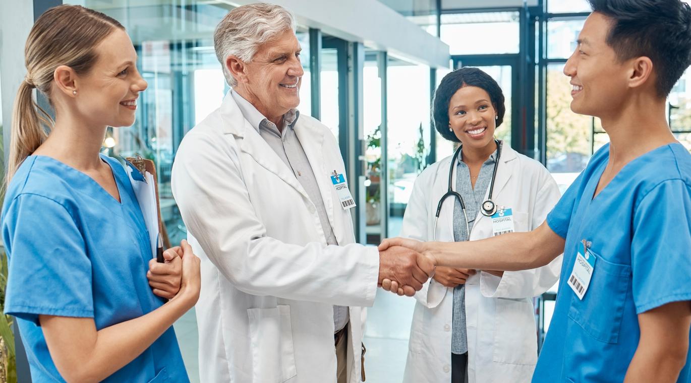 en and women medical group together for a handshake, teamwork and collaboration with trust and support