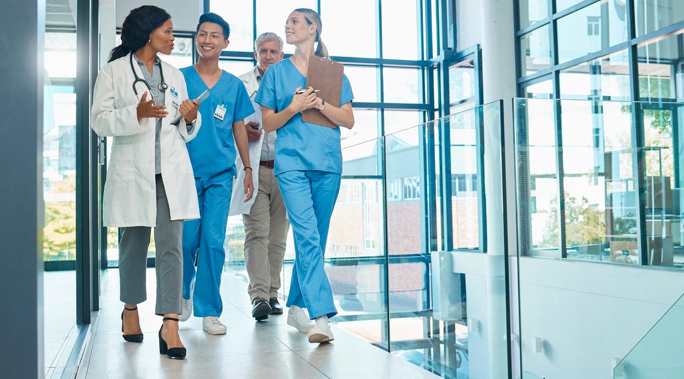 physicians walking and talking in hospital hallway