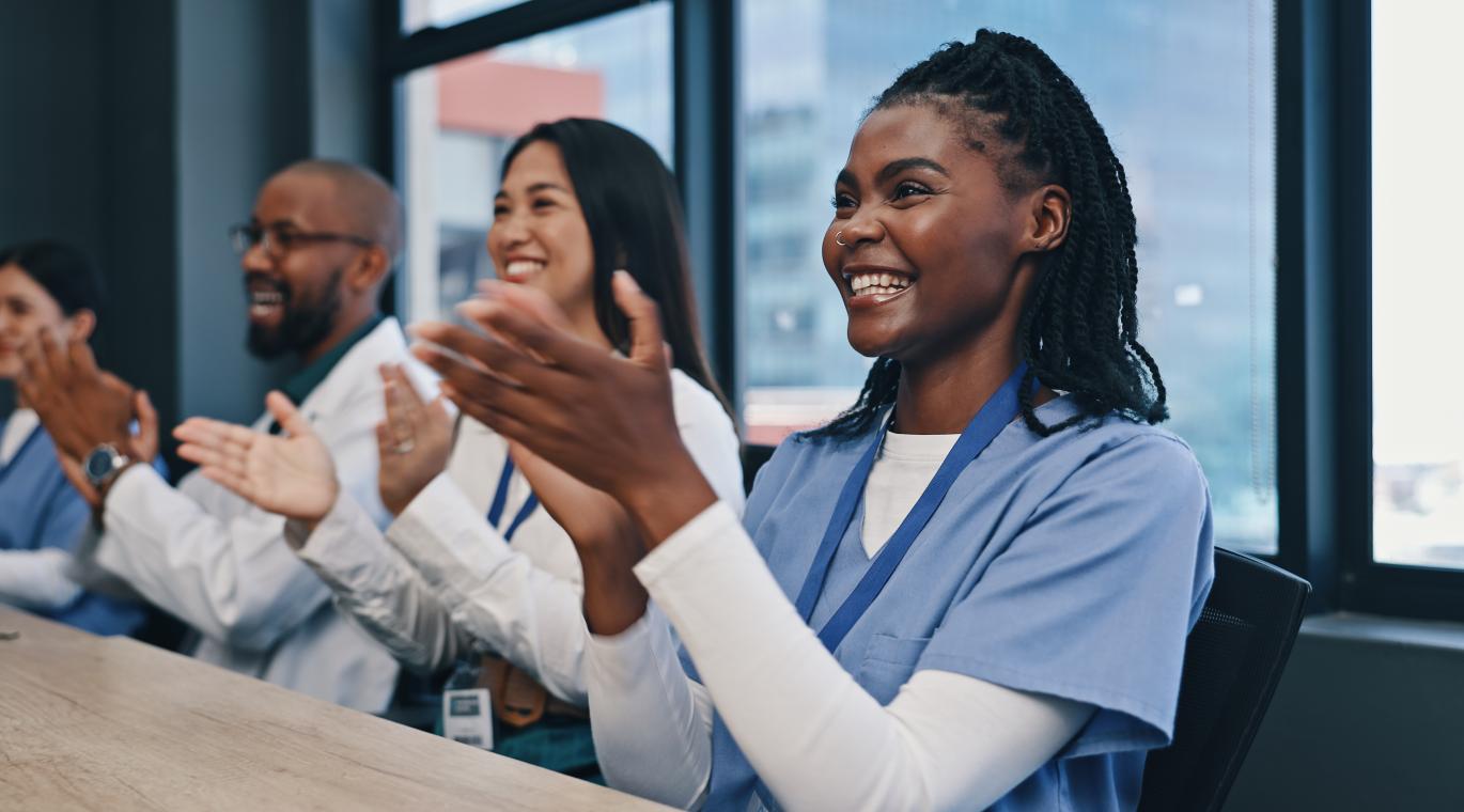 Teamwork, applause with nurses and doctors meeting with diversity, congratulations and support in onboarding. Medical achievement, men and nurses in office clapping hands at hospital