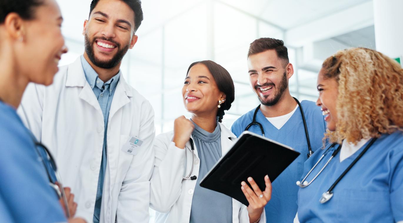 Physicians working together on an iPad