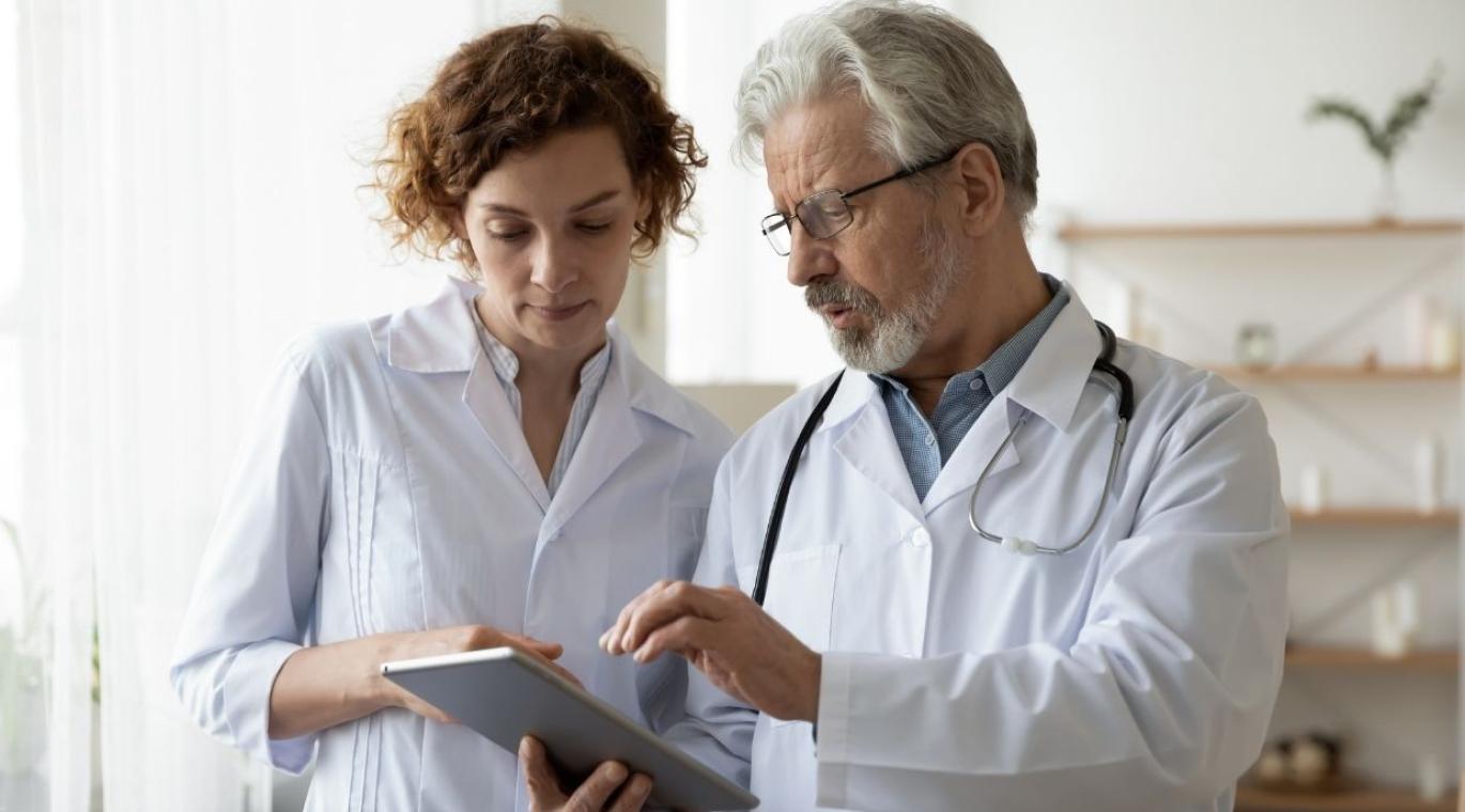 physicians talking while looking at tablet