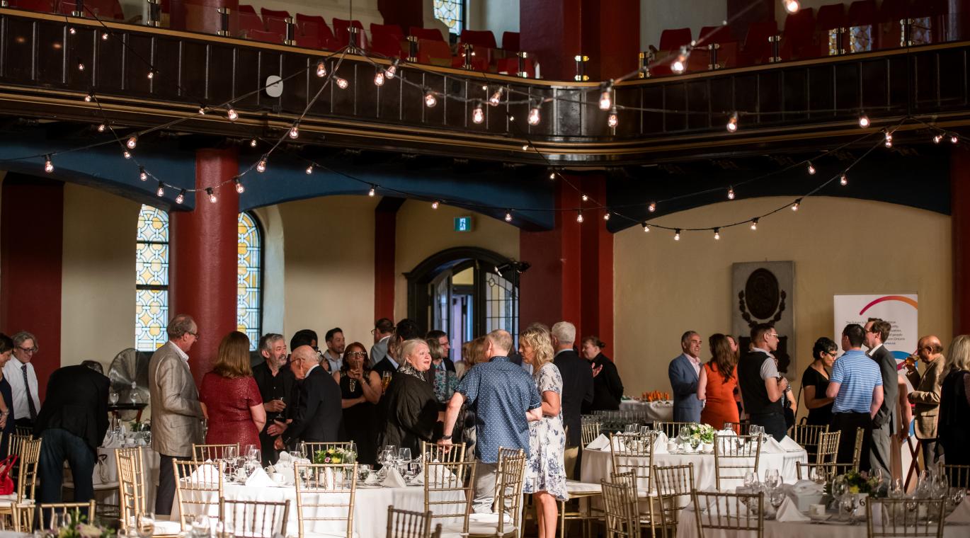 Room shot of guests sitting at tables