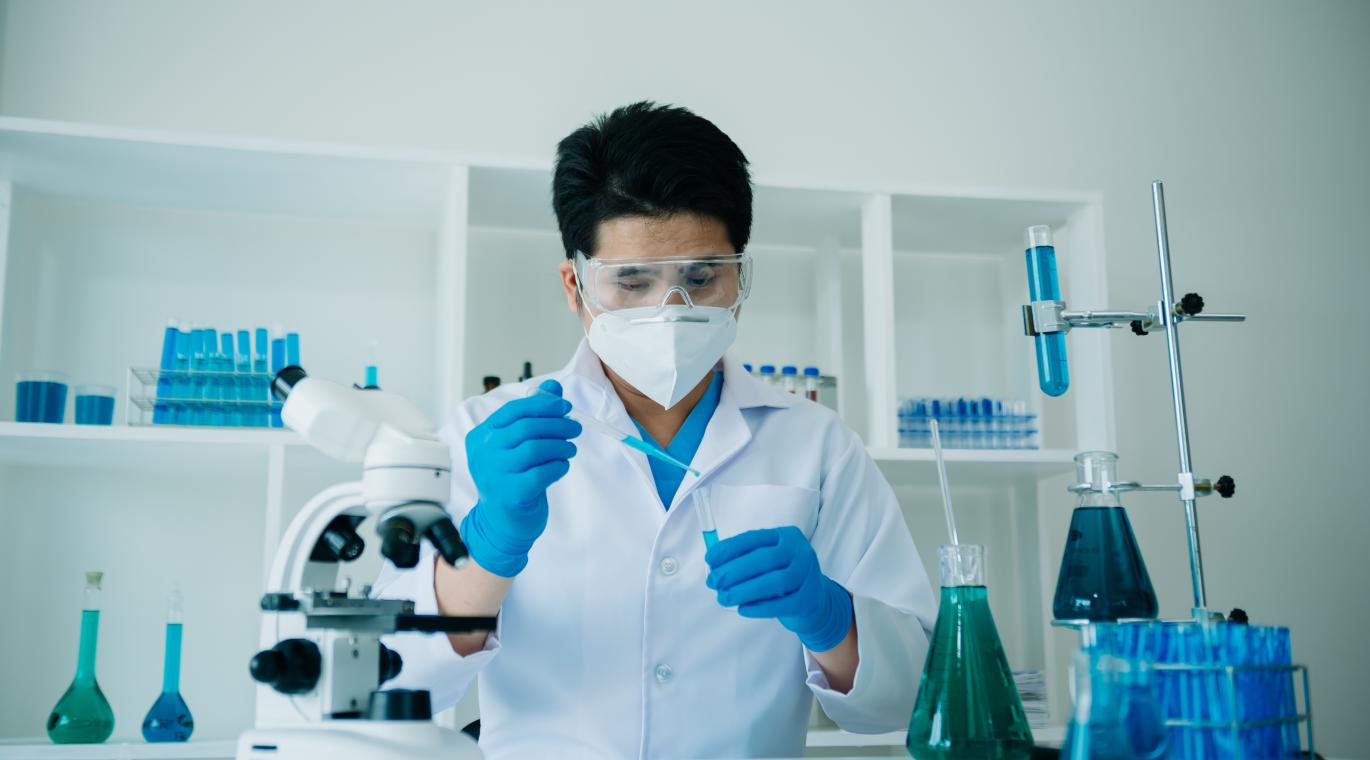 male physician working with test tubes in a lab