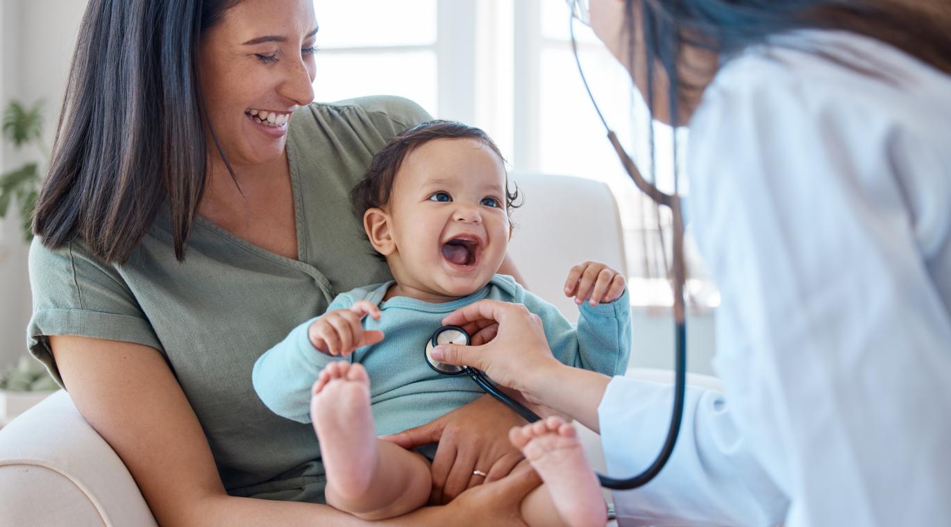 doctor using a stethoscope on baby