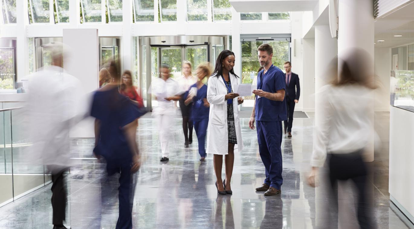 two physicians having a conversation in a hallway