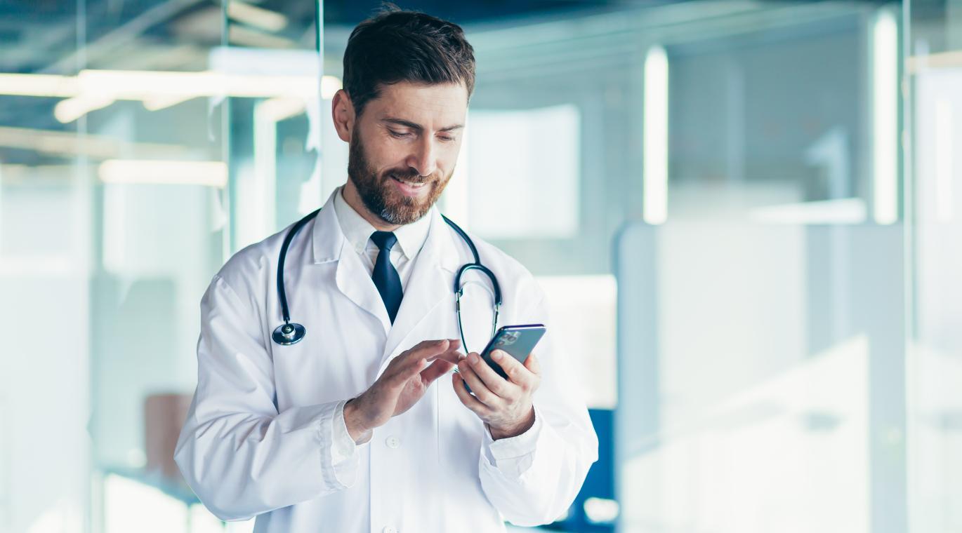 male physician looking at phone