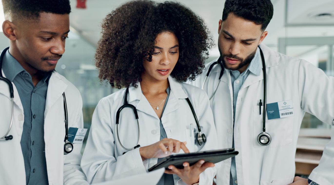 Tablet, team doctors and woman typing, reading or teamwork on medicine study, cardiology research or healthcare. 