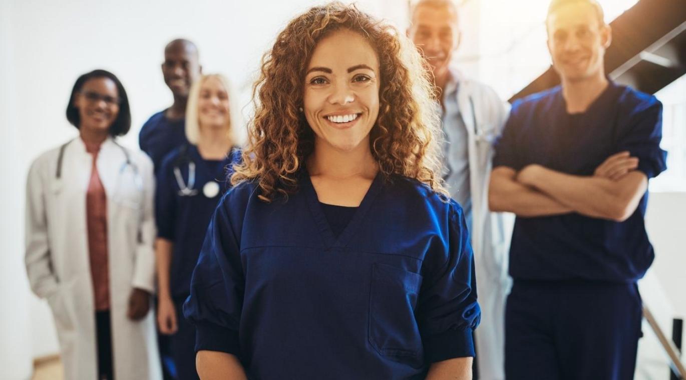 female physician standing in large group