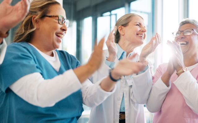 Doctor, support and applause in celebration for team unity, healthcare achievement or goal at the hospital.
