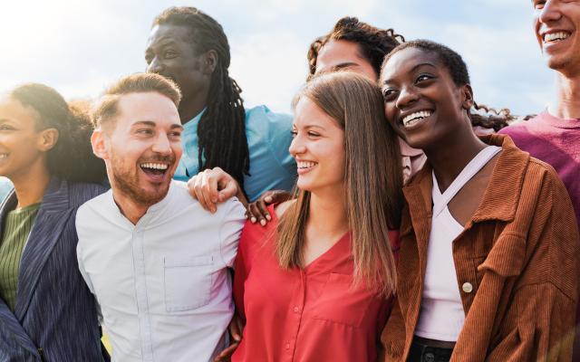 group of people arm in arm smiling