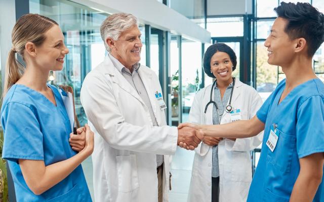 en and women medical group together for a handshake, teamwork and collaboration with trust and support