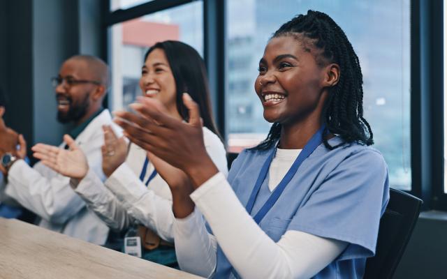 Teamwork, applause with nurses and doctors meeting with diversity, congratulations and support in onboarding. Medical achievement, men and nurses in office clapping hands at hospital
