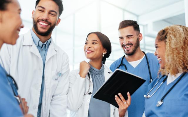 Physicians working together on an iPad