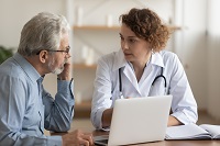 doctor talking to a patient at a table
