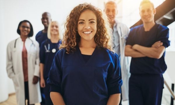female physician standing in large group