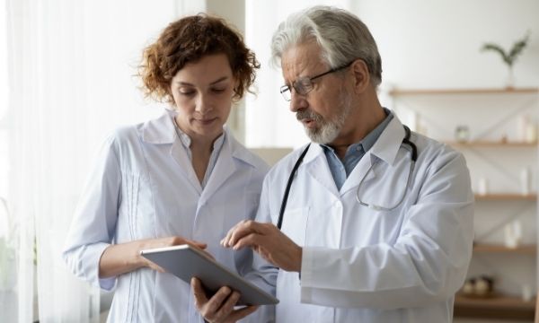 two physicians sharing a tablet